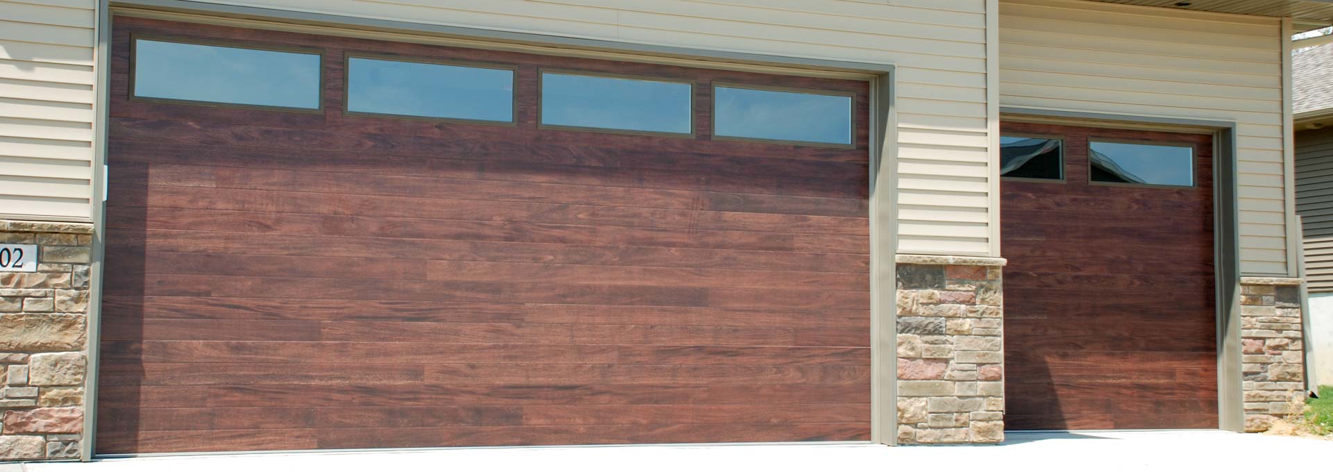 The unique look of stained wood on a maintenance free metal door.